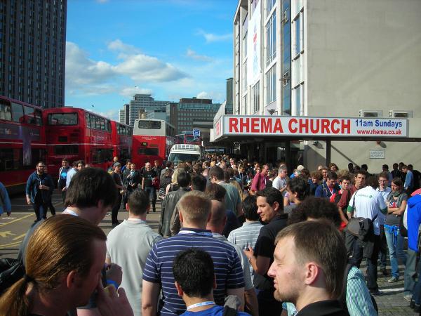 DrupalCon attendees queued up to fill a fleet of iconic London double-decker buses