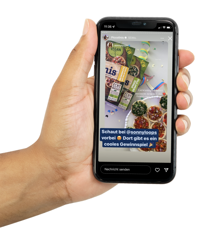 Person holding a phone mock-up with a screenshot of Piccolinis Wagner