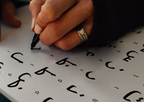 Woman writing the arabic alphabet 