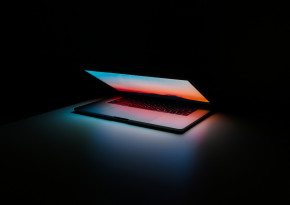 Laptop in dark background and neon lights